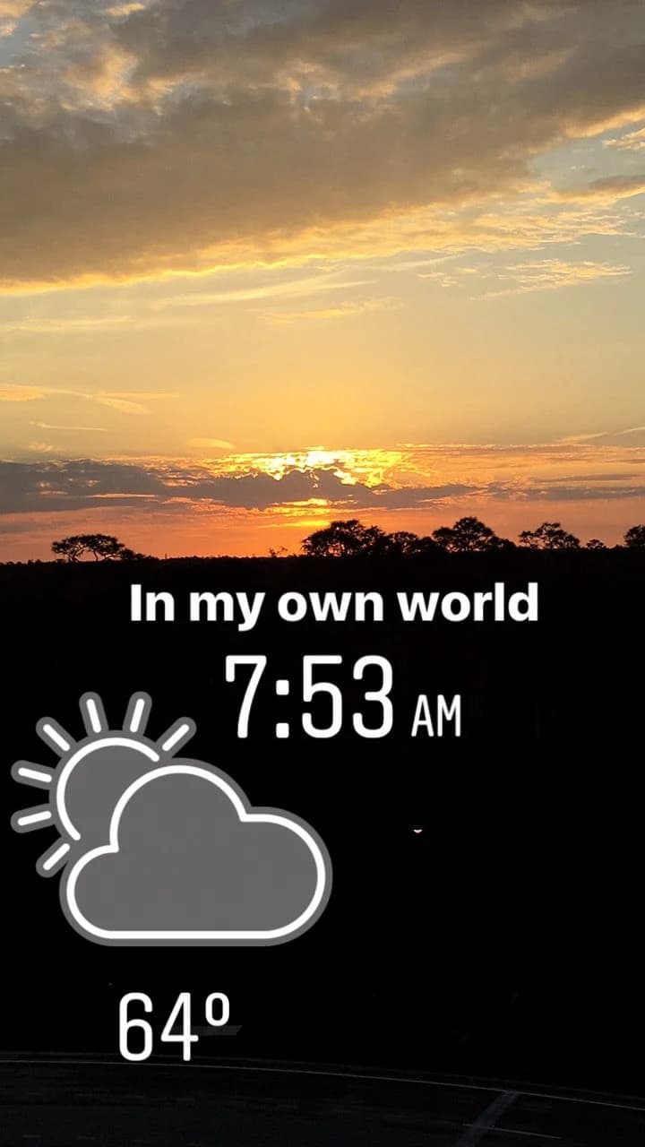 A sunrise photograph with the original words ‘In my own world’ and a 7:53 AM clock.