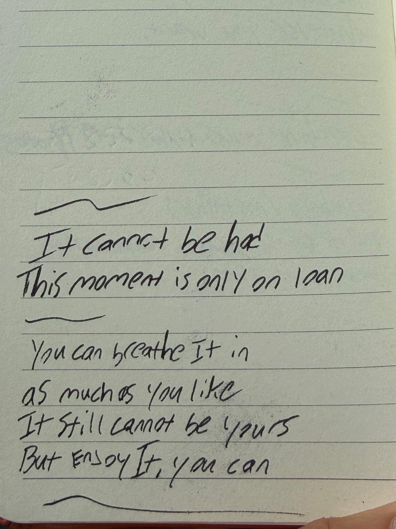 A notebook reads: It cannot be had. This moment is only on loan. You can breathe It in as much as you like. It still cannot be yours. But Enjoy It, you can.
